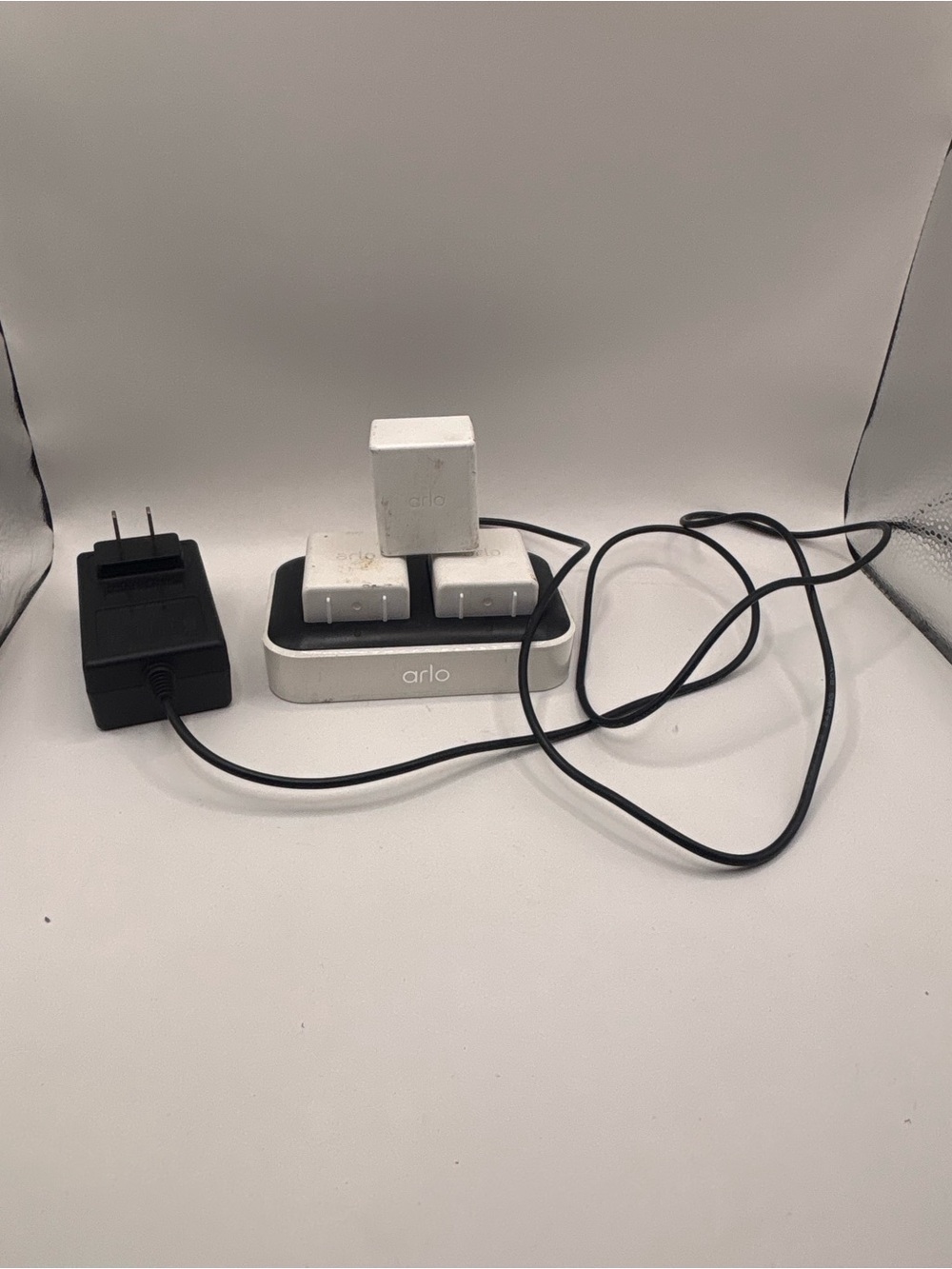Arlo Charging Dock with White Batteries and Black Adapter